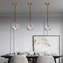 Glass globe pendant light over the island pendant lights
