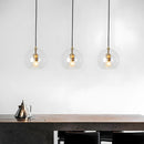 Glass globe pendant light over the island pendant lights