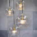 Glass globe pendant light over the island pendant lights